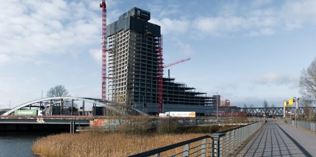 Construction of a tall building on the water.